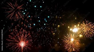 A fireworks display with many different colored fireworks. The fireworks are lit up and are in the air