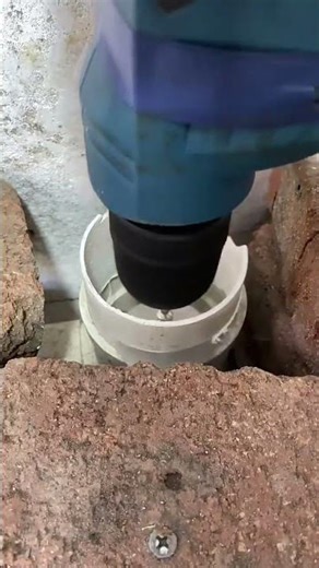 technician uses internal PVC pipe cutter attached to power dril to cleanly trim pipe from the inside