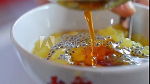 Putting Javanese sugar into a bowl of ice dawet cendol, street food