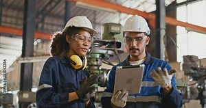 Mechanical worker at a factory plant operating a production line machine and setting it for work