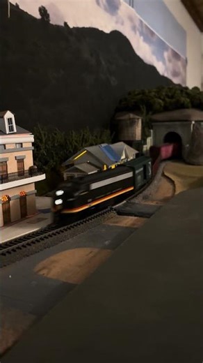 HO scale Athearn/Roundhouse F7 locomotive heading west through town at night. #modeltrains