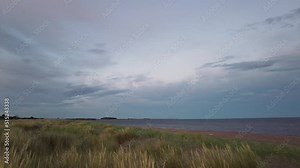 Pan across the sand dunes and the Firth of the Tay late afternoon as the sun starts to set