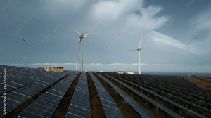 windmill and solar panel farm producing renewable energy with wind and sun