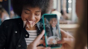 beautiful african american woman eating spaghetti at restaurant with friend using smartphone taking photo having fun sharing weekend together on social media 4k