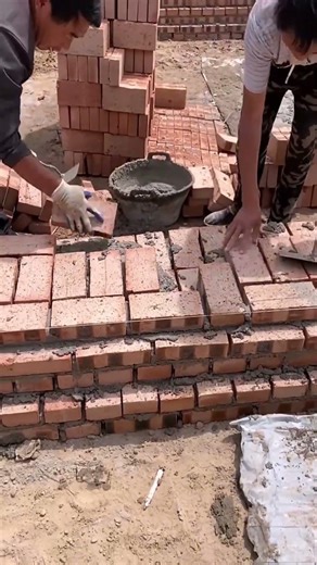 Two masons laying bricks teamwork smooth wall build process #build #shorts