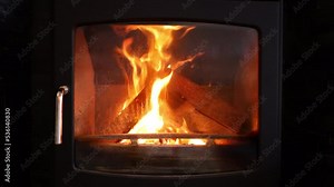 Logs on fire burning in a wood burner, slow motion