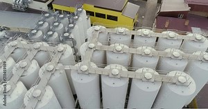 Aerial view of big grain elevators. Facilities for processing grain with bunkers for cleaning, drying up and temporary storage. Industrial architecture of tanks for a brewery.