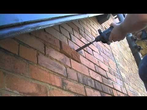 removing a blown brick from a wall and replacing