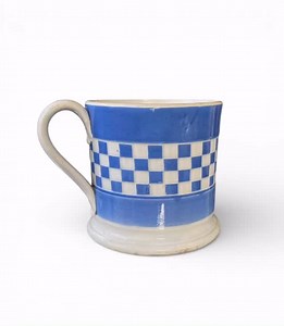 Staffordshire pearlware blue banded mug, c. 1830. £170.00 www.philipcarrol.com Staffordshire Potteries pearlware banded mug, c. 1830. The large mug, engined turned with a band of blue and white chequered motif, in slight relief, between two solid bands of blue. Set upon a pedestal foot, and having a simple strap handle, with foliate terminals. All beneath a pearlware glaze. Height – 9.8 cm, 3 7/8”. Width (Handle to rim) – 13 cm, 5 1/8”. Diameter – 10.2 cm, 4”. Condition – Typical age related wea
