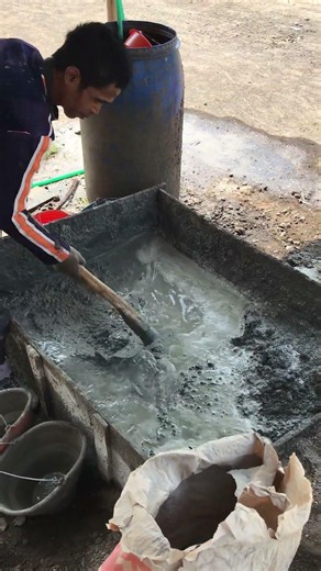 mixing the mixture of cement, concrete sand, and aggregate.