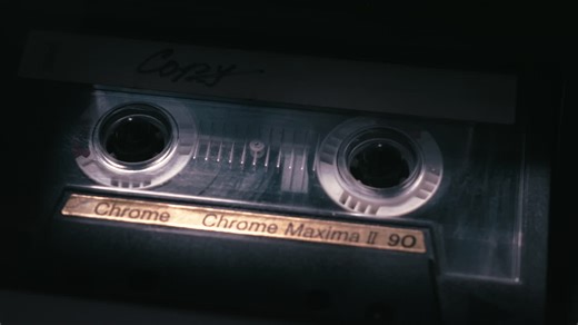 Close up of analog cassette tape spinning in dark scene, crime style mood, police investigation, witness statement recording, | Premium Stock Video Footage