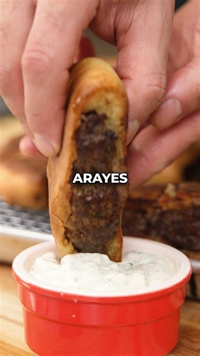 Here's how to make one of my favorite Lebanese dishes, Arayes. Step 1: Prep the Filling Add lean ground beef to a large bowl. Grate in one clove of garlic and 1/4 of a white onion, squeezing as much moisture out as possible. Add chopped parsley, salt, pepper, a tiny pinch of cinnamon, cumin, and ground allspice before mixing well. Step 2: Bake the Pita Sprinkle flour onto a table or countertop, and add the pita dough. Coat each ball of dough in flour, and use your hands to gently form the dough 