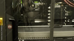 Plastic Injection Moulding Machine Making Car Parts and Putting Them on the Assembly Line