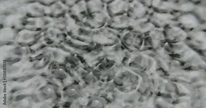 Cymatic patterns on water. Loopable static shot of vibrating water.