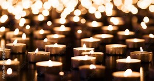 Flickering candles on black granite