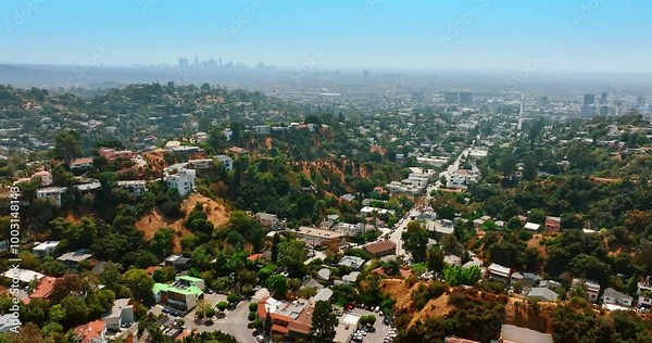 Residential area on the hills of Hollywood. Panorama of Los Angeles, California, USA with hazy downtown skyline at backdrop. Top view.