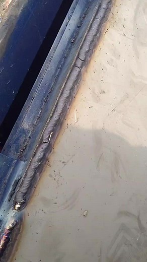 Welding Process: Close-Up of Rod and Metal Seam