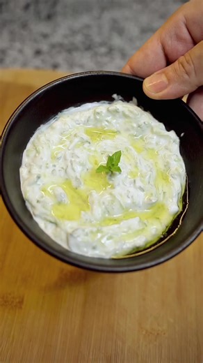Creamy Tzatziki Salad Ingredients: - 160g Greek yogurt - Fresh thyme, mint, and basil - 3 cucumbers - 1 clove garlic - Salt - Vinegar - Olive oil Instructions: - Grate cucumbers and marinate in salt and vinegar for 30 minutes. Drain excess liquid. - Combine chopped garlic, herbs, salt, and olive oil. - Mix yogurt, cucumbers, and dressing. Serve as a salad or a light meal. Tips: For a tangier flavor, add more vinegar. Experiment with different herbs and spices. Smacznego 😊 #tzatziki #salad #gree