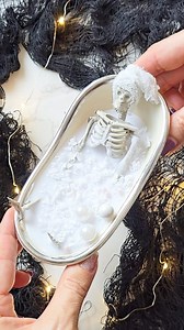 Skeleton's "Me Time" Candle DIY 🫧💀🛁 What a fun little easy DIY, I wanna make more 😆 I saw michaels skeleton bathtub decor in their new halloween collection and couldn't wait to make it into the candle!🕯 All you need is: Decorative bathtub Dollar store white candle Dollar store skeleton garland Cheesecloth or white fabric Decorative beads, pearls Melt the candle in a pot of simmering hot water. Remove the wick using tweezers, add it to the bottom of the tub supporting with two chopsticks or 
