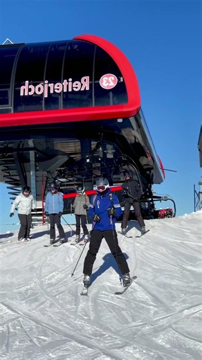 Skiers Descending Brighton Slope Under Clear Blue Sky: Brighton’s name visible on the ski lift