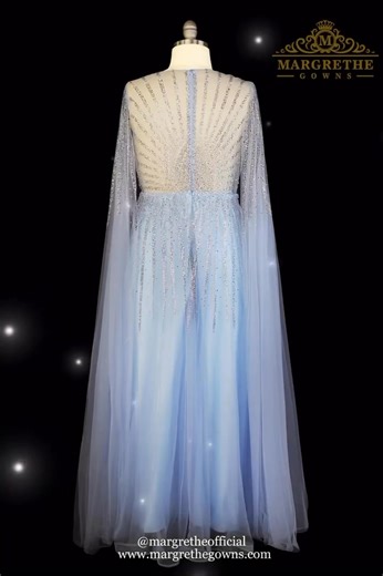 A whisper of elegance in light blue — this A-line gown captures the magic of timeless glamour. Crafted from soft tulle, it glimmers with intricate beadwork from the sheer, beaded bodice, where it melts into a dreamy cascade of airy tulle. The floor-length tulle sleeves add an ethereal flow, giving every movement a touch of grace and fantasy. A gown made to shimmer, float, and mesmerize. ✨💙 #margrethestunner #margrethegowns Like it? Come and wear one of these stunning creations at Margrethe Gown