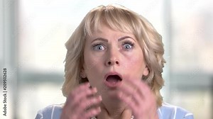 Face of shocked terrified woman. Female face with wide opened eyes and mouth expressing shock and horror. Negative human emotions and facial expressions.