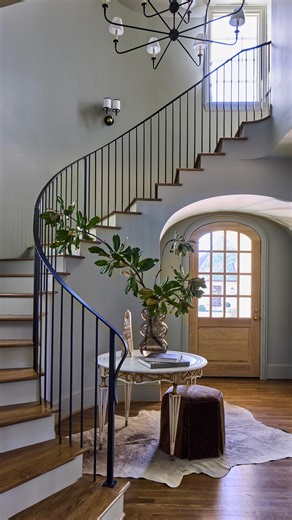 Foyer transformation at one of our recently wrapped projects. A curved staircase, arched entry doorway, and custom iron railing create a sculptural moment as soon as you step inside. Soft hues and natural light highlight the flow and movement of the space. Featuring an antique table sourced by our team from the markets of Paris, France. Comment "SHOP" for the link. #interiordesign #entryway #homedesign #homerenovation #birminghamal | River Brook Design & Construction
