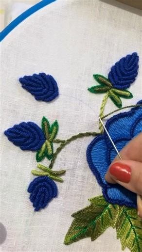 Whisper Thread on Instagram: "This dimensional embroidery primarily uses the bullion knot (also known as bullion stitch) for the large, textured blue flowers. The leaves appear to be created using a combination of techniques, likely the fishbone stitch or perhaps a type of fly stitch for the raised effect.🤍🌼 Technique Details Flowers: The characteristic coiled appearance and raised, 3D effect of the blue flowers are achieved through the bullion knot. This stitch involves wrapping the thread ar