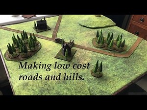 Magnetic paper roads and foamboard contoured hills. Cohesive aesthetics?