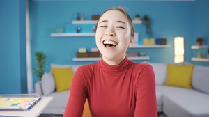 Happy Asian woman laughing at camera. Young happy Asian woman laughing at camera and happy.