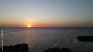 sunset aerial overlooking Tampa Bay from Cockroach Bay, a small section of downtown St. Petersburg, Florida is visible