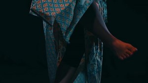 a traditional Javanese dancer dances and moves her feet very agilely while performing on stage