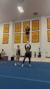 Coed cheerleaders performing advanced stunting techniques in practice