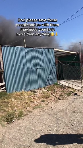 Intense Fire Engulfs Structure with Dark Smoke Rising