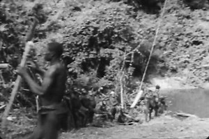 1930s - African pygmies make a bridge over a river to avoid crocodiles in the 1930s.