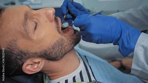 Dentist examining patient teeth with dental instruments in clinic