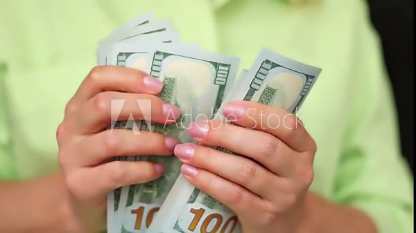 Girl counting US dollar banknotes