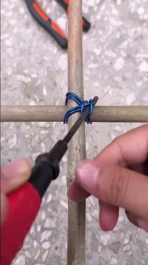 The process of securely tying bamboo poles together with wire for construction