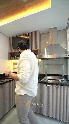 Sophisticated gourmet area with prominent slatted wood paneling and LED lighting.