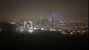 Dallas, Texas skyline at night with foggy weather and drone video wide shot stable.