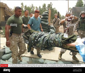 NO FILM, NO VIDEO, NO TV, NO DOCUMENTARY - U.S. Marines and sailors with Bravo Surgical Company carry a wounded comrade in an ambulance near Fallujah, Iraq, after a suicide bomber attacked an armored Marine reconnaissance unit on Friday, April 30, 2004. Photo by Carol Rosenberg/South Florida Sun Sentinel/KRT/ABACA Stock Photo - Alamy
