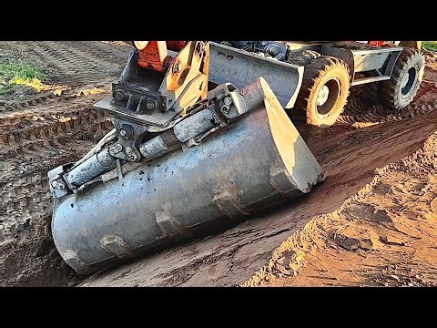 Right Bucket for the Job! Terex 1605M Atlas Excavator is Building Dirt Wall as a Landscape Feature.