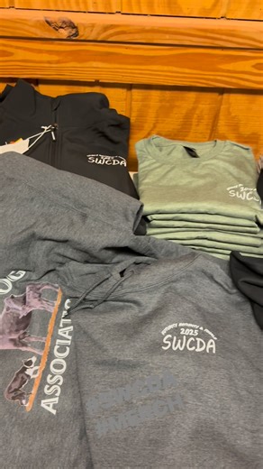 SWCDA merch is available in Vernon! Swing by the indoor arena to get t-shirts, hats & hoodies. All online preorder items are available in the crows nest as well!! #Swcda #merch #2025swcdafuturity | Southwest Cattledog Association