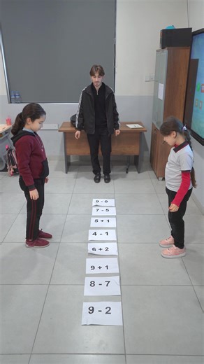 ‏➕✨ Learning math through movement and fun! Our students are stepping onto each equation, thinking carefully, and solving with confidence. This interactive activity helps them build strong number skills while staying active and engaged. We are so proud of their focus, teamwork, and excitement for learning! 📚🌟 ➕✨ فێربوونی بیرکاری لە ڕێگەی جوڵە و خۆشی! خوێندکارەکانمان هەنگاو دەنێنە سەر هەر هاوکێشەیەک و بە وردی بیردەکەنەوە و بە متمانەوە چارەسەر دەکەن. ئەم چالاکییە کارلێککارییە یارمەتیان دەدات کە 