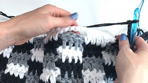 Crochet an easy plaid blanket! No carrying yarn or cutting at the end of every row. Carry yarn along the edge as you work. Watch the full tutorial on YouTube https://www.mjsoffthehookdesigns.com/crochet-rustic-farmhouse-throw-blanket/ | MJ's Off the Hook Designs