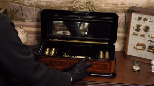 Reuge Music Box 50 note Limited edition Được chế tác bởi bàn tay cẩn thận của những người thợ thủ công của REUGE, chiếc hộp nhạc sở hữu cơ cấu 50 notes tinh xảo với 5 cylinder xoay vòng, lưu giữ 10 bản nhạc cổ điển. Mỗi nốt nhạc ngân vang lên như lời thì thầm đầy cảm xúc, gợi nhắc về những ký ức đẹp đẽ, những khoảnh khắc thanh bình đã qua. Reuge Music Box 50 note là sự kết tinh tuyệt mỹ giữa nghệ thuật chế tác thủ công của Thụy Sĩ và tinh thần tôn vinh âm nhạc cổ điển vượt thời gian. Phần thân h