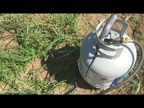 Using a propane torch to kill weeds and grass