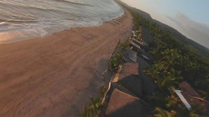 Dynamic drone tour of a beach at sunset - Free Stock Video