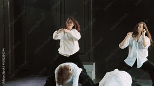 Dancing talented women. Beautiful young women with perfect body dancing indoors. Elegant females dancing modern dance. Modern professional dances. Group of stylish young people dancing. 4K, UHD