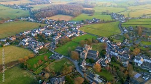 Aerial drone footage of Cartmel village and Cartmel Priory, a historic site in the Lake District.